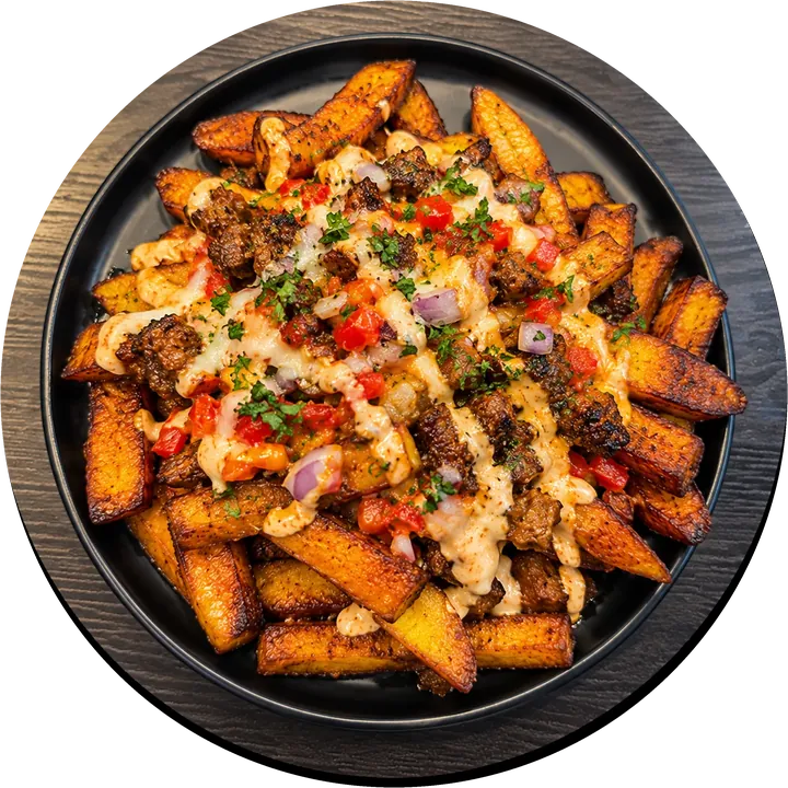 Loaded plantain fries topped with beef, sauce, onions and peppers