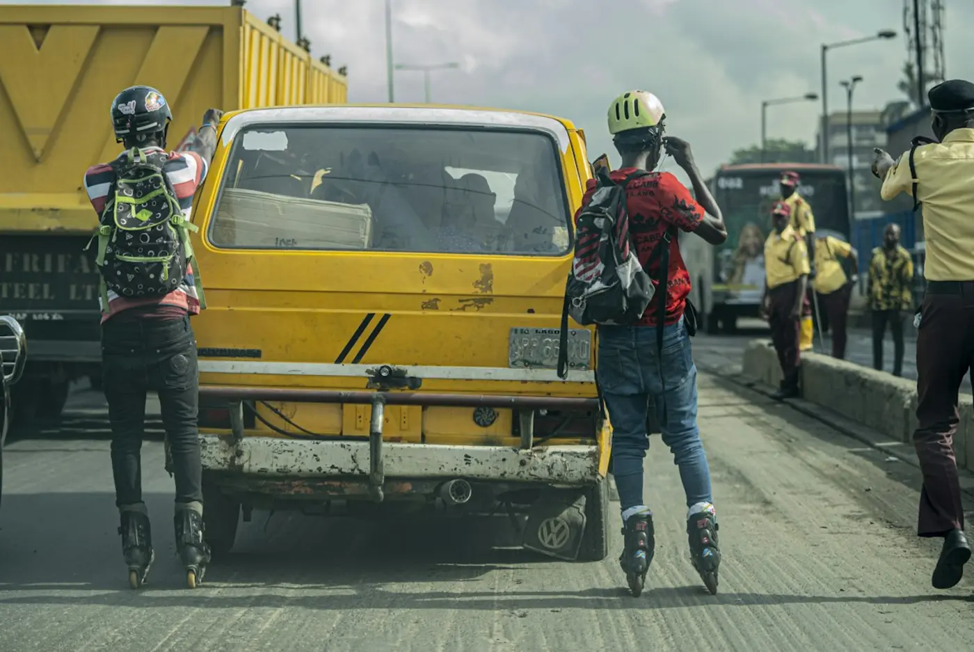 A yellow danfo bus on a busy Lagos road