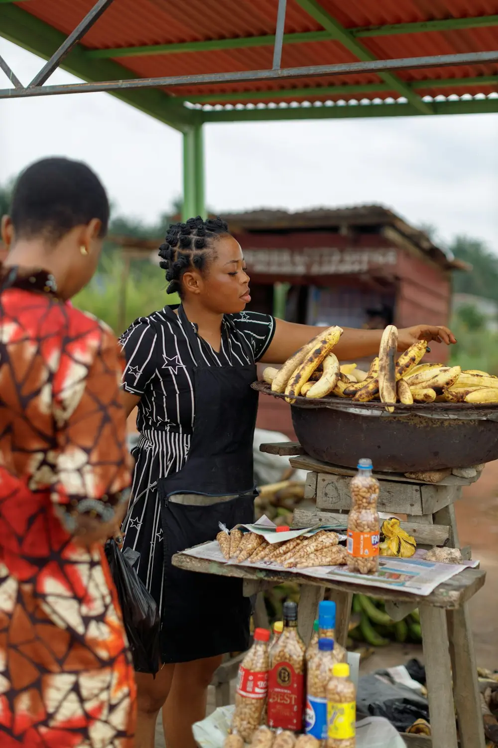 A woman frying plantain at a roadside food stall in Lagos